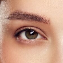 Close up woman face with green exotic leaf