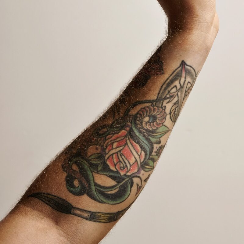 Tattoed arm and hand with aeropress filter cap